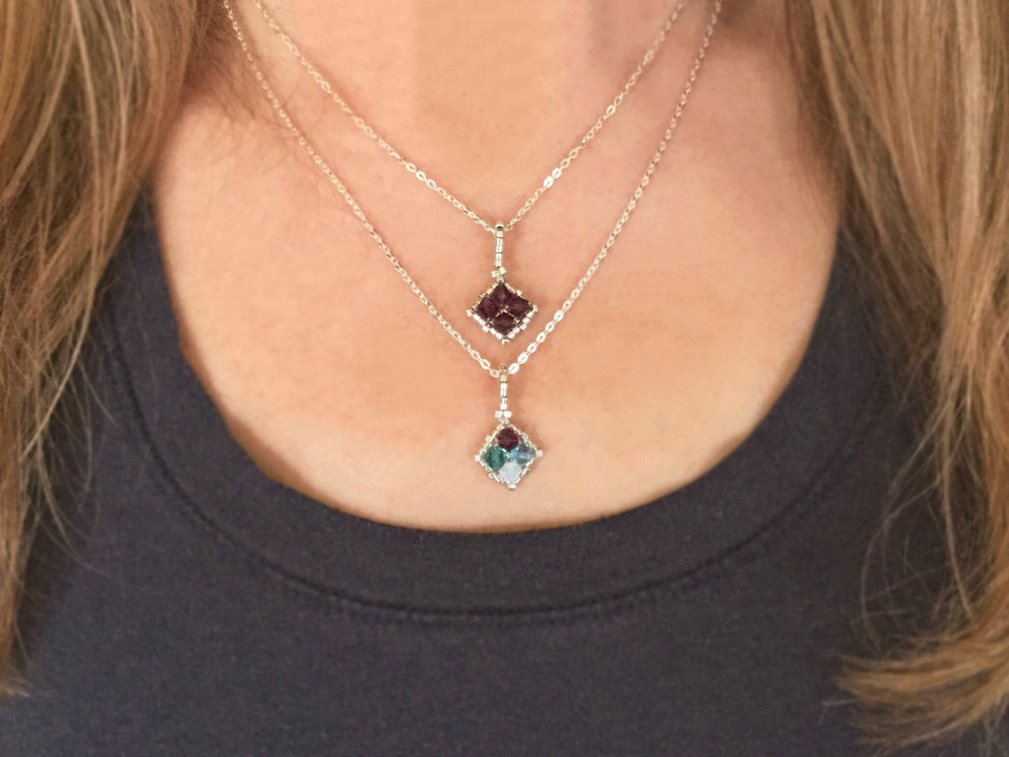 birthstone family necklace layered with a solid colored birthstone pendant in the 16 inch & 18 inch silver chains 